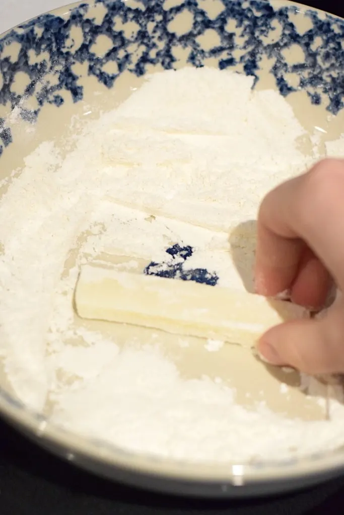 rolling mozzarella in coconut flour