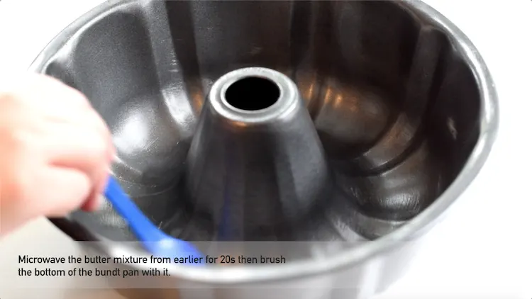 brushing bundt pan with garlic butter